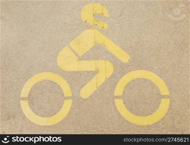 yellow motorcycle road sign painted on a yellow pavement