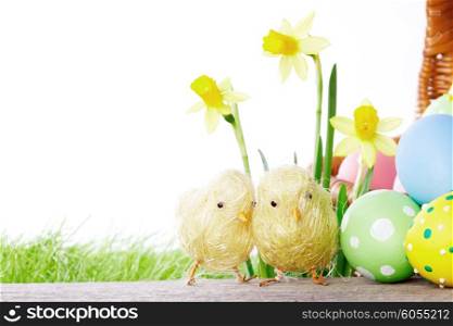 Yellow narcissus Flowers and easter eggs on spring grass background
