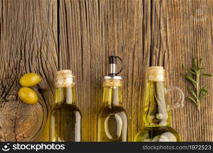 yellow olives oil bottles wooden background. High resolution photo. yellow olives oil bottles wooden background. High quality photo