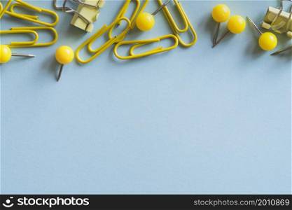 yellow paper clips push pins binder clips