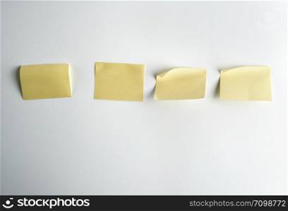 yellow paper stickers on white background, close up