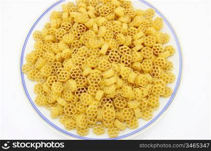 Yellow pasta in the form of wheels on a white background a structure