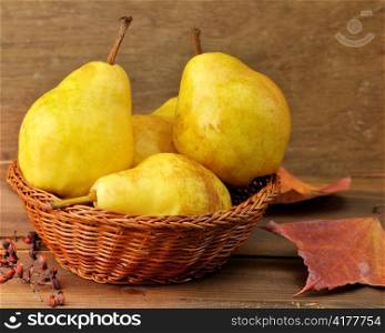 Yellow Pears In A Basket On Wooden Background
