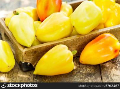 yellow peppers in the wooden box