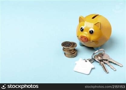 yellow piggy bank with keys copy space background
