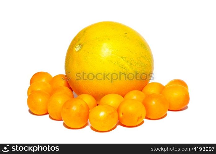 Yellow plums and the melon isolated on white.