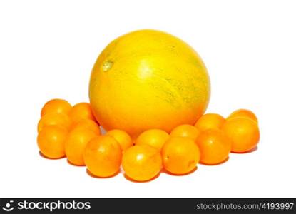 Yellow plums and the melon isolated on white.