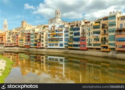 Yellow, red and orange facades of houses in Girona and Cathedral. Spain, Catalonia.