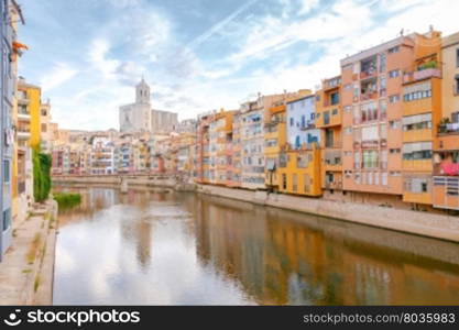 Yellow, red and orange facades of houses in Girona and Cathedral. Spain, Catalonia.