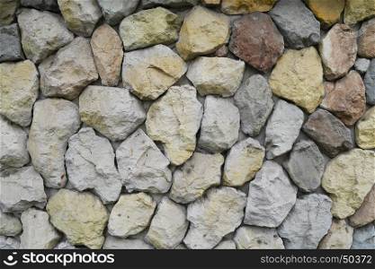 yellow, red, blue, stones and pebbles on gray wall, background, closeup
