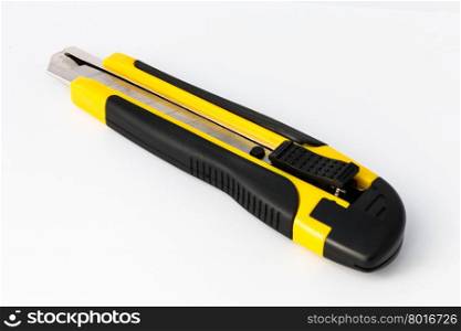 Yellow retractable utility knife on white background