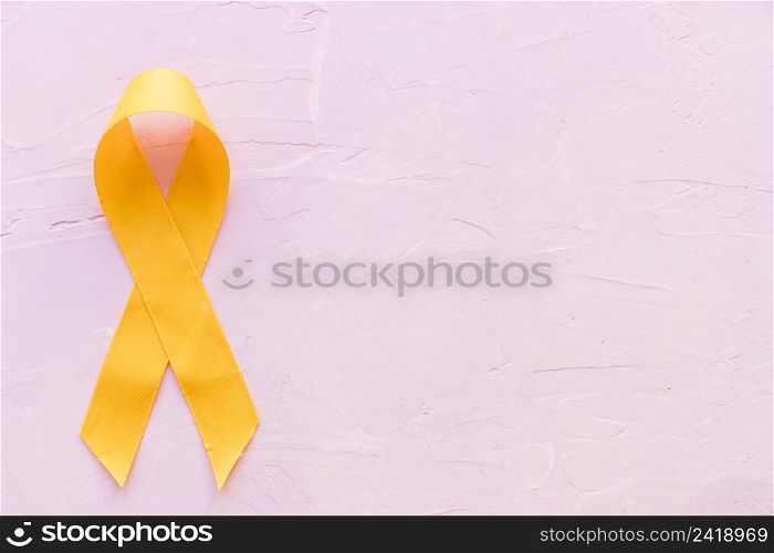 yellow ribbon symbolic color sarcoma bone cancer pink backdrop