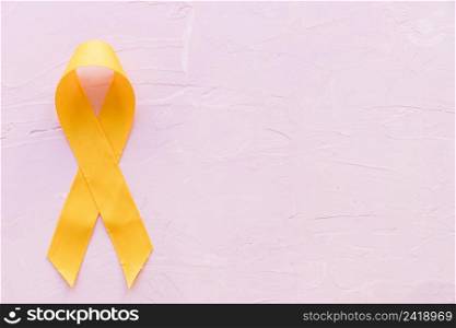 yellow ribbon symbolic color sarcoma bone cancer pink backdrop