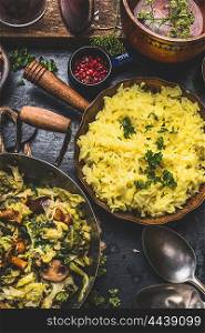 Yellow rice dish with stewed chopped cabbage and mushrooms on rustic kitchen background, top view. Vegan and Vegetarian cooking .