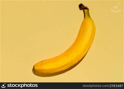 Yellow ripe banana on a bright yellow background. fruit background idea