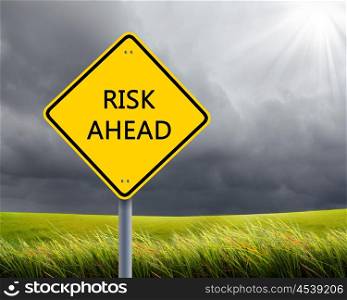 yellow road sign as a warning of risk ahead