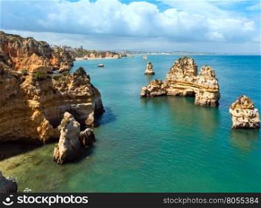 Yellow rocky coast (Ponta da Piedade, Lagos town, Algarve, Portugal). All people are unrecognizable.
