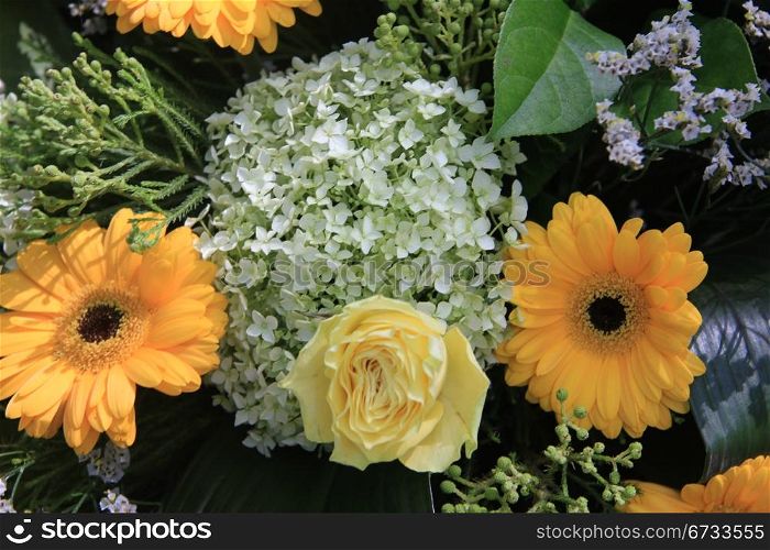 yellow roses and gerberas in a floral arrangement