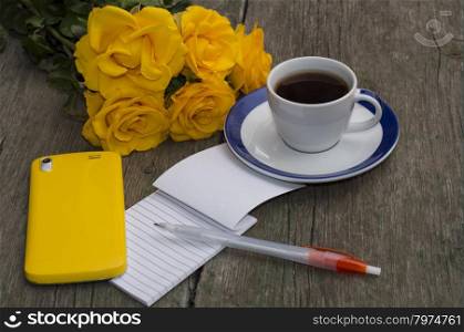 yellow roses, notebook, coffee and yellow phone