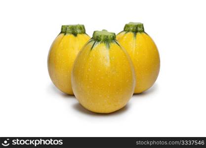 Yellow round courgettes on white background