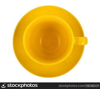 Yellow round empty tea cup on a saucer