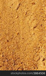Yellow sand with small colored stones as a texture