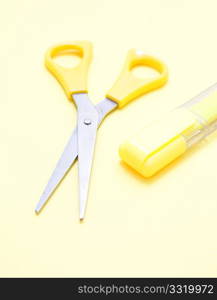 Yellow scissors and a marker