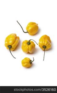 Yellow Scotch bonnet chili peppers on white background