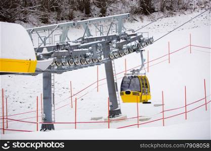 Yellow ski lift cabin on the ski slope at Austrian Alps