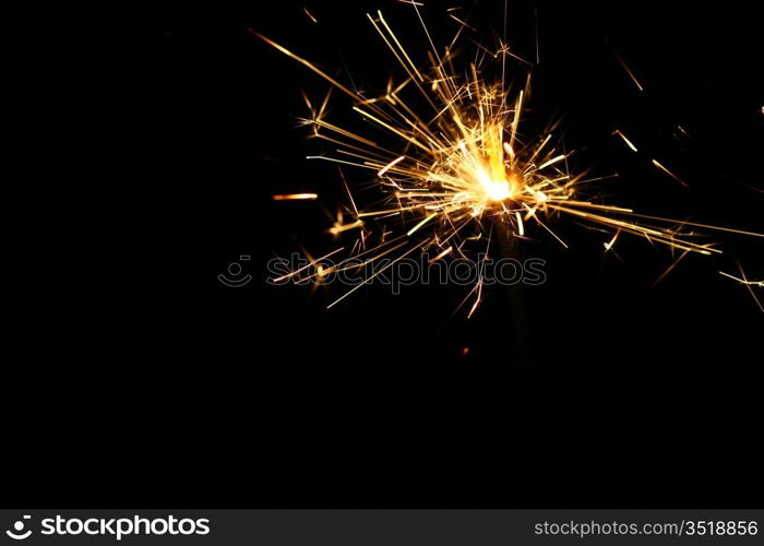 yellow sparkler holiday background on black