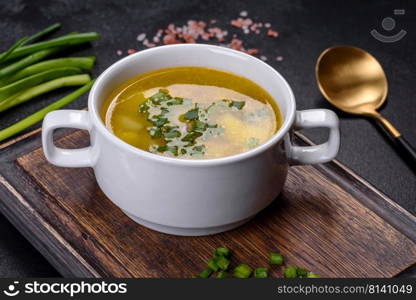 Yellow split pea soup with bacon. Space for text, top view. Fresh pea soup in bowl on black background. Cooking at home