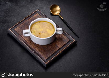 Yellow split pea soup with bacon. Space for text, top view. Fresh pea soup in bowl on black background. Cooking at home