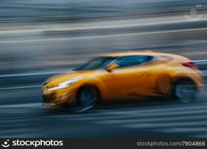 Yellow Sports Car in a Blurred City Scene