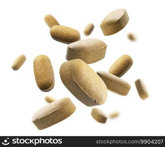 Yellow tablets levitate on a white background.. Yellow tablets levitate on a white background