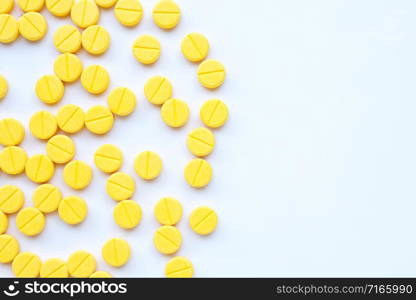 Yellow tablets of Paracetamol on white background. Copy space