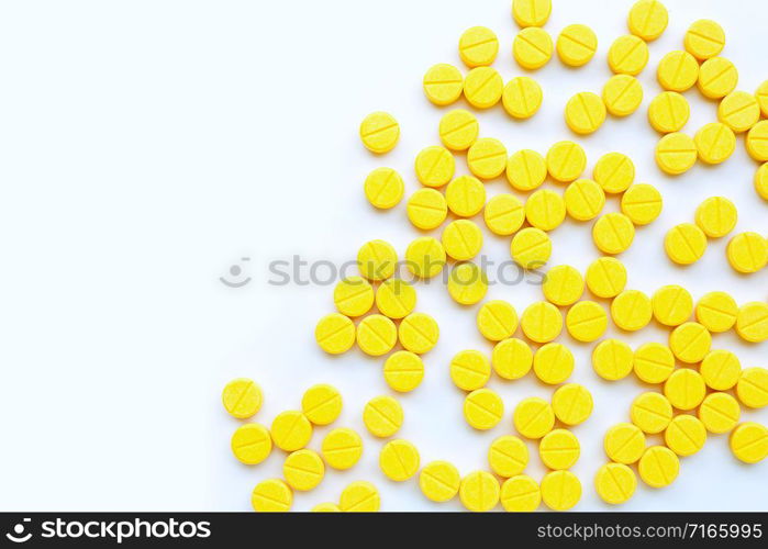 Yellow tablets of Paracetamol on white background. Copy space