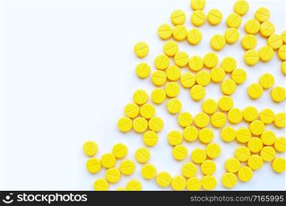 Yellow tablets of Paracetamol on white background. Copy space
