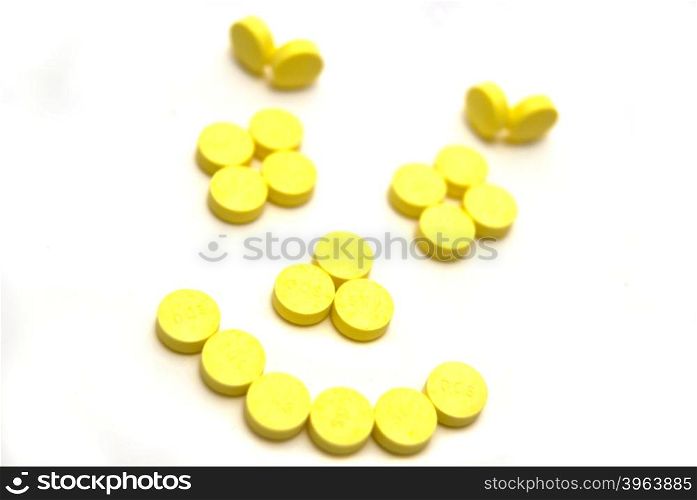 Yellow tablets on white background
