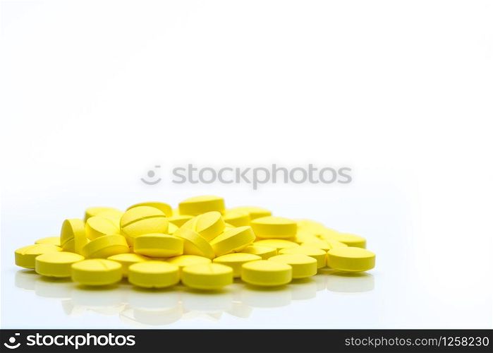 Yellow tablets pills isolated on white background with copy space. Pile of medicine. Painkiller tablets pills.