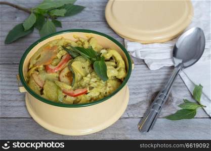 Yellow Thai curry in a bowl on wooden table.. Yellow Thai curry in a bowl on wooden table