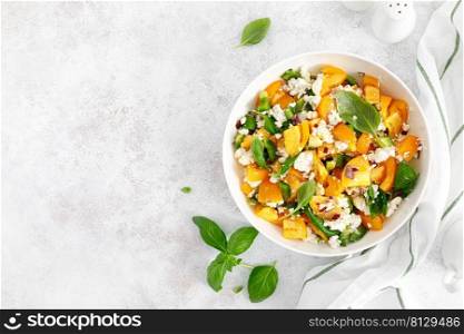 Yellow tomato salad with green paprika, cottage cheese and basil. Healthy food, diet. Top view