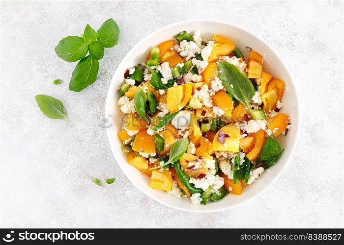Yellow tomato salad with green paprika, cottage cheese and basil. Healthy food, diet. Top view