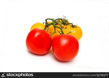 Yellow tomatoes with two red tomato isolated on a white background. Red And Yellow Tomatoes