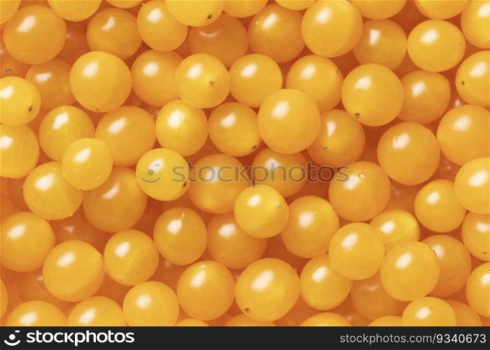 Yellow Tomberry tomatoes close up full frame as background