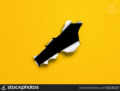 Yellow torn paper with black hole. blank background template. Yellow torn paper with black hole