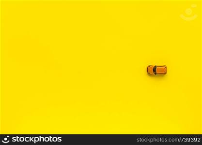 Yellow toy car on a yellow background. Free space for text. Little Yellow toy car on a yellow background. Free space for text