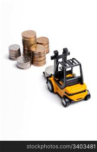 Yellow toy forklift and money. Yellow toy forklift moving stocks of coins
