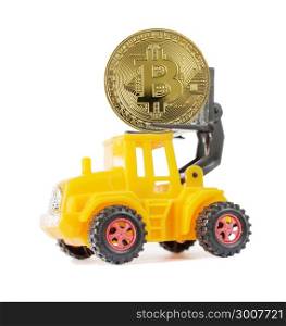 Yellow toy forklift transports a symbolic coin of bitcoin crypto currency, new digital money in cyber world, isolated on a white background, side view