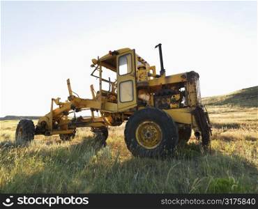 Yellow tractor in field.