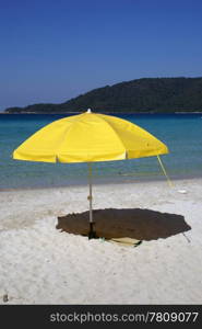 Yellow umbrella on the sand, Perhentian island, Malaysia